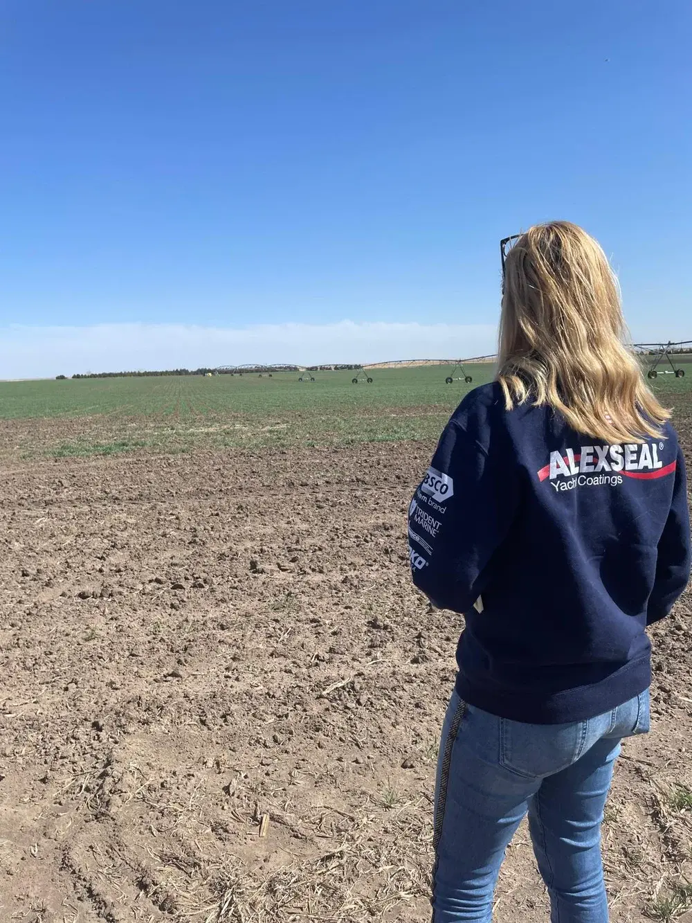 Tjasa Krause looking across an irrigated field, from the SDVoyager feature